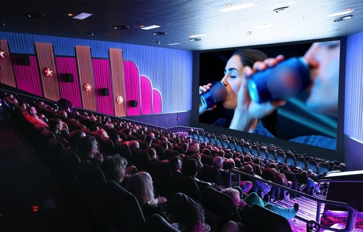 Cinema hall with an advertisement on the big screen and a seated audience
